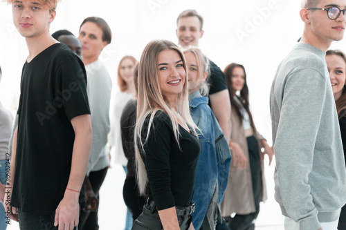 casual young woman standing among diverse young people.