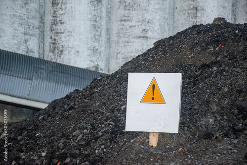 warning sign on pile of contaminated soil 