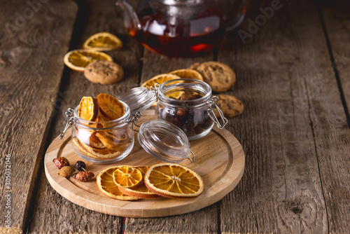 Glass Jars of Dried Citrus and Berry for Tea Ingredients for Tasty Hot Beverage Wooden Tray Wooden Background Dried Oranges Horizontal Copy Space