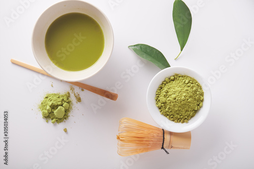  Matcha green tea powder view from above, traditional matcha tea preparing , white background. Flat lay 