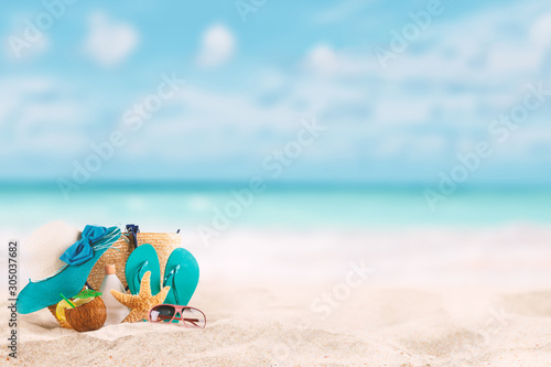 Summer background with accessories for beach holidays. tropical landscape with sand in the foreground and blurred background. concept of summer vacation in hot destinations - warm contrast filter