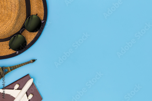 Outfit and accessories of traveler on blue background with copy space, Travel concept, Overhead view of Traveler's accessories, Essential vacation items, Travel concept on blue background. top view
