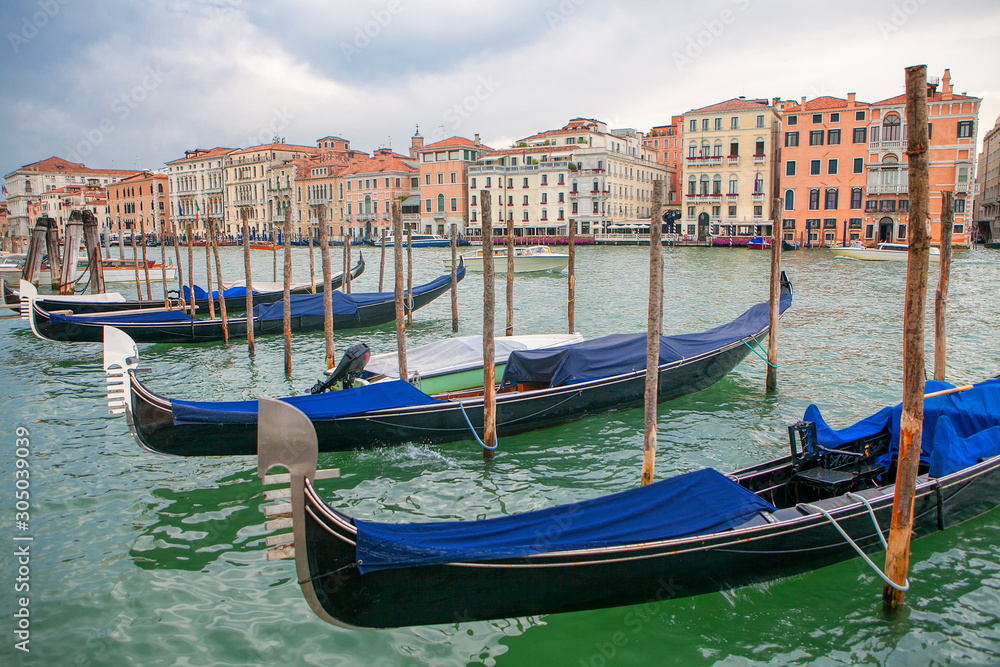 Gondolas moored to the wooden harbour in Venice