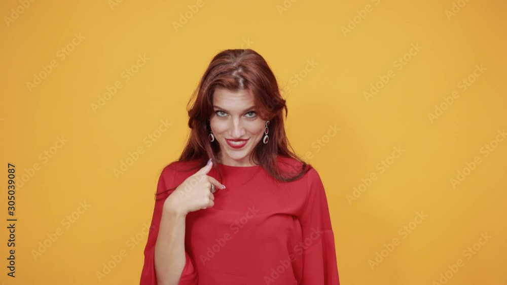 Lady in red dress is charming and signalling someone to talk to her on call as she likes that person. She is in other words flirting with that person as she is charming and attracted to that person. Lady in red dress is charming and signalling someone to talk to her on call as she likes that person. She is in other words flirting with that person as she is charming and attracted to that person.
