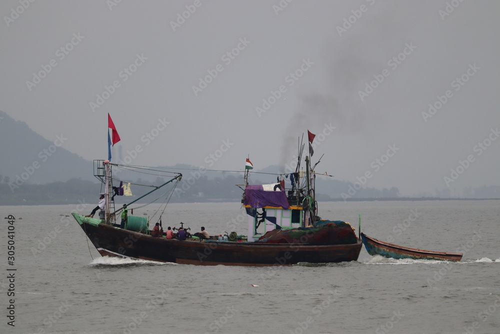 Mumbai, Maharastra/India- November 22 2019: A big fishing boat. Group of fishermen on a mission to catch fishes from the sea. Mumbai, Maharastra/India- November 22 2019: A big fishing boat. Group of fishermen on a mission to catch fishes from the sea.