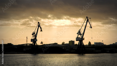 crane silhouettes in port
