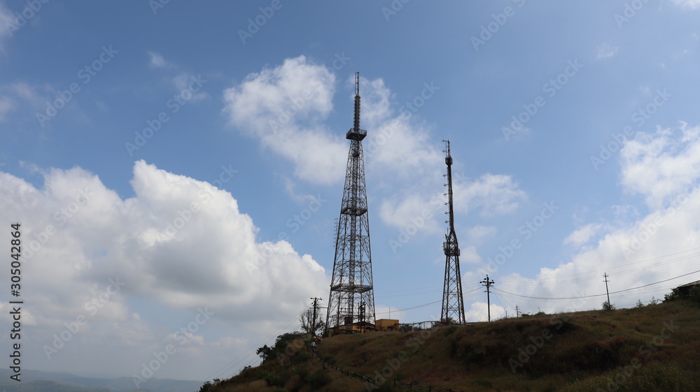 Mobile tower standing on the mountain top with clear sky. Telecom company powered mobile communication. Mobile tower standing on the mountain top with clear sky. Telecom company powered mobile communication.