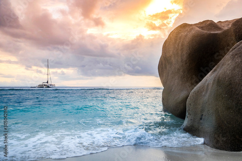 peaceful holiday paradise concept with a beautiful beach and an amazing sunset over the indian ocean on the seychelles