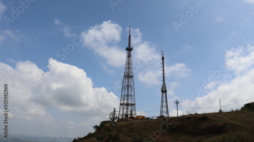 Mobile tower standing on the mountain top with clear sky. Telecom company powered mobile communication.