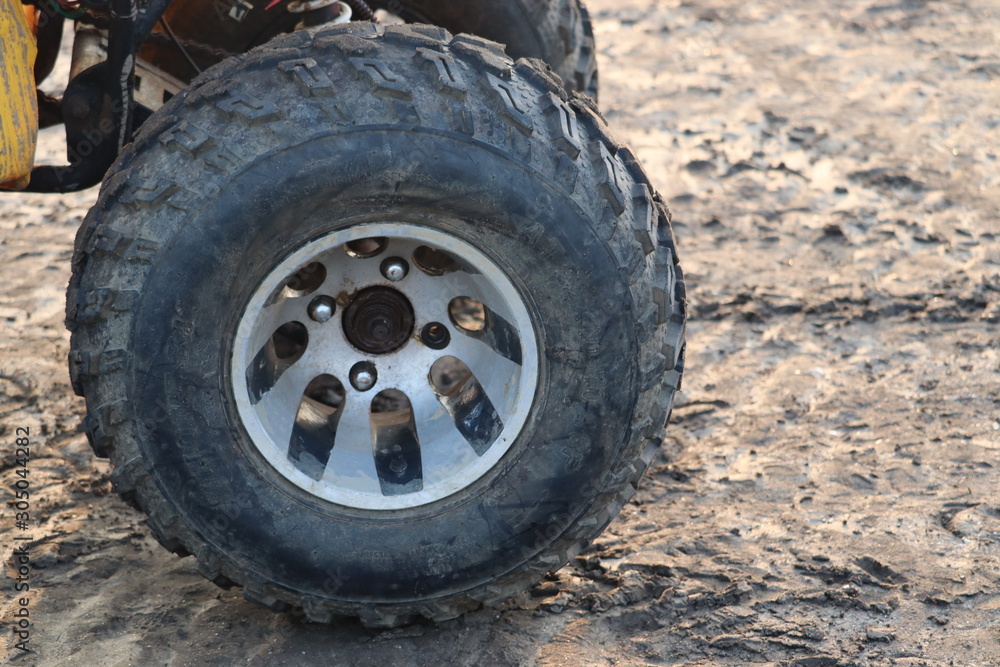 Black rubber tyre of a small tractor or car. Black rubber tyre of a small tractor or car.