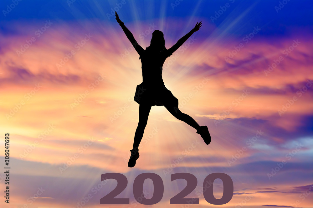 Silhouette of young woman jumping over the numbers 2020 years with beautiful sunset, concepts of news year and business target