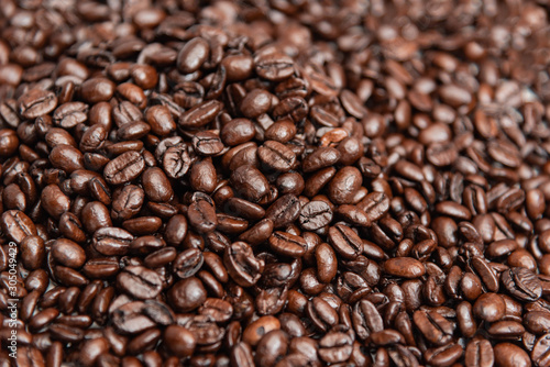 Close up pile of roasted coffee beans, shallow depth of field.