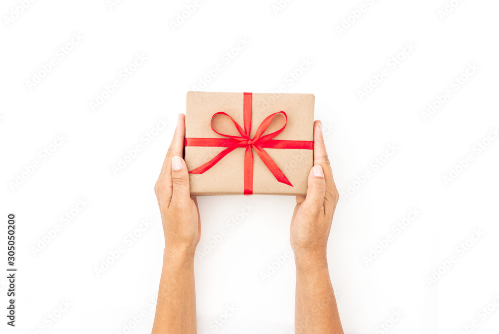 Female hands holding present box or gift box package in the craft paper