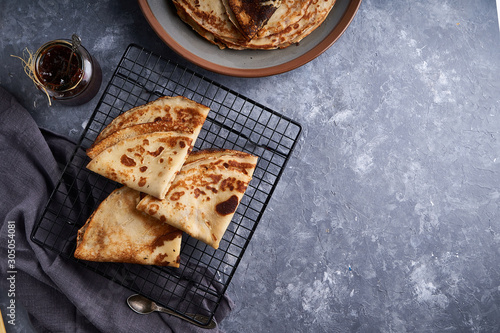 tasty homemade pancakes with berry jam served on gray stone table Top view Copy space photo