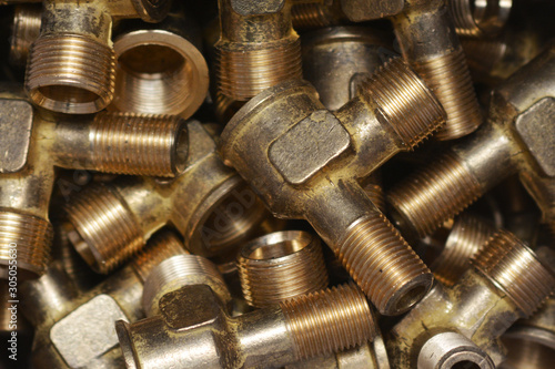 Bronze bushing inserts as background. Close-up of golden metal parts. Mechanical engineering. 