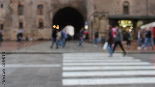 BOLOGNA, ITALY - 22 May 2019: People walking on the streets under a light rain.  Blurry HD Video