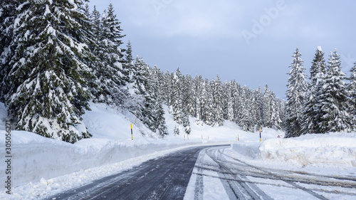 San Bernardino, Switzerland. Driving on a road after a snowfall. Driving shot, driver point of view. POV, vehicle point of view. Camera on car roof. White trees. Winter contest