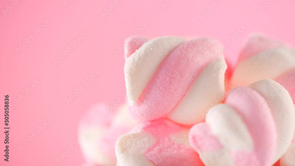 Marshmallow. Close-up of Marshmallows colorful chewy candy, rotation over pink background. Sweet food dessert in a cup with hot chocolate close-up. 4K UHD video Marshmallow. Close-up of Marshmallows colorful chewy candy, rotation over pink background. Sweet food dessert in a cup with hot chocolate close-up. 4K UHD video