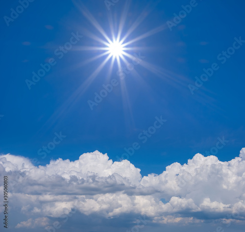 bright blue cloudy sky with sparkle sun, outdoor background