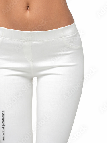 slim legs of a young girl in leggings on a white background. Concept of a fit figure and the absence of problem areas.