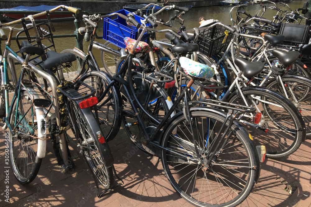 Bicycle Parking on the waterfront, Amsterdam, Netherlands, concept of ecology and healthy lifestyle Bicycle Parking on the waterfront, Amsterdam, Netherlands, concept of ecology and healthy lifestyle