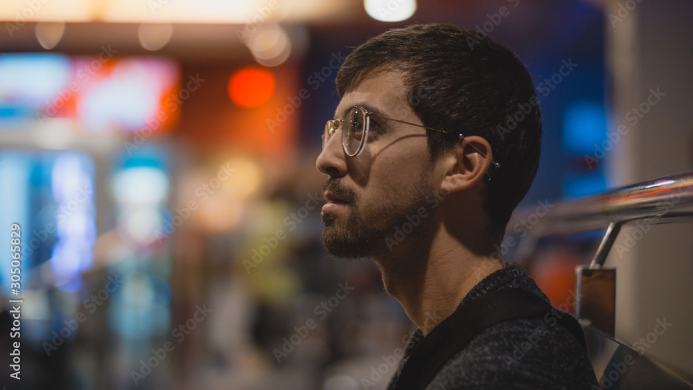 Portrait of a boy with piercing and glasses leaning on a room Portrait of a boy with piercing and glasses leaning on a room