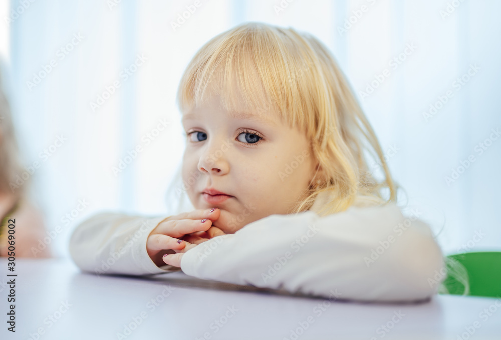 Cute little blonde girl portrait. Preschool beaty with blue eyes. New methods of education. Cute little blonde girl portrait. Preschool beaty with blue eyes. New methods of education.