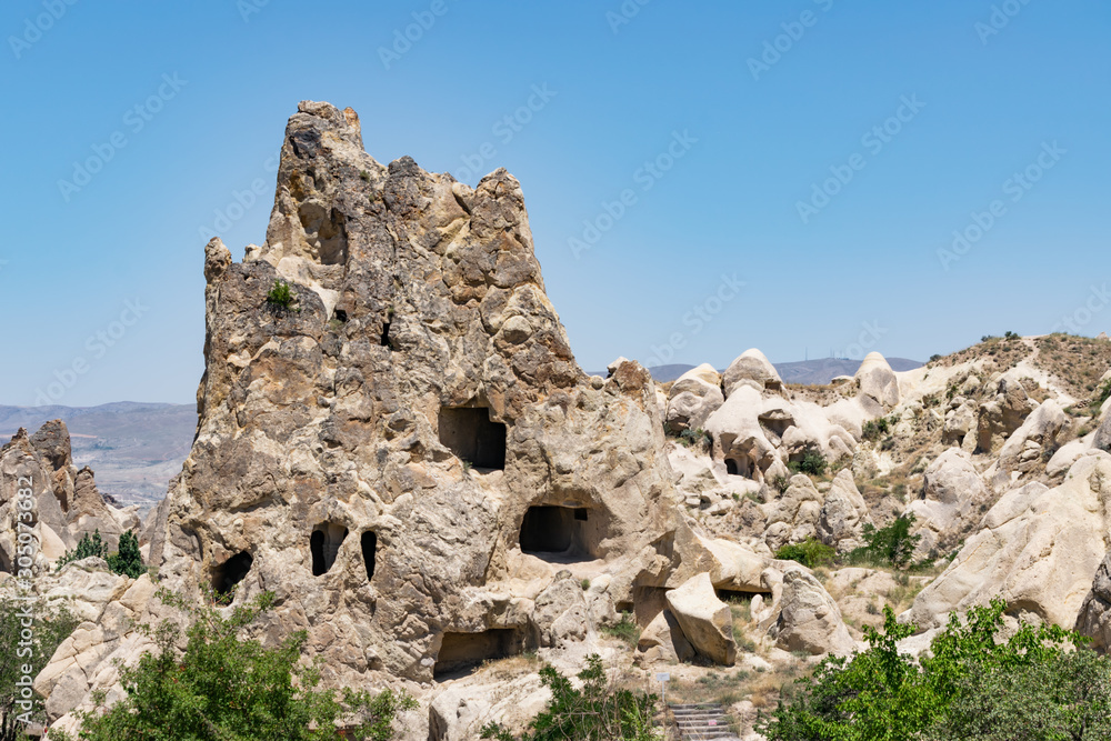 Ancient volcanic stones with caves and holes, Cappadocia, Turkey.