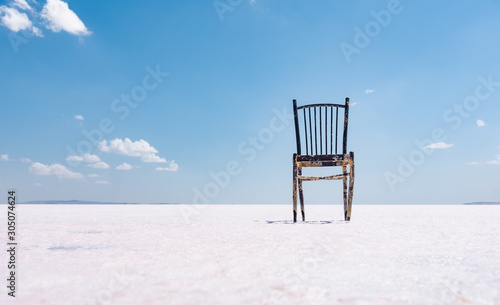 Old rustic empty chair at dry salt lake, Minimalism concept. photo