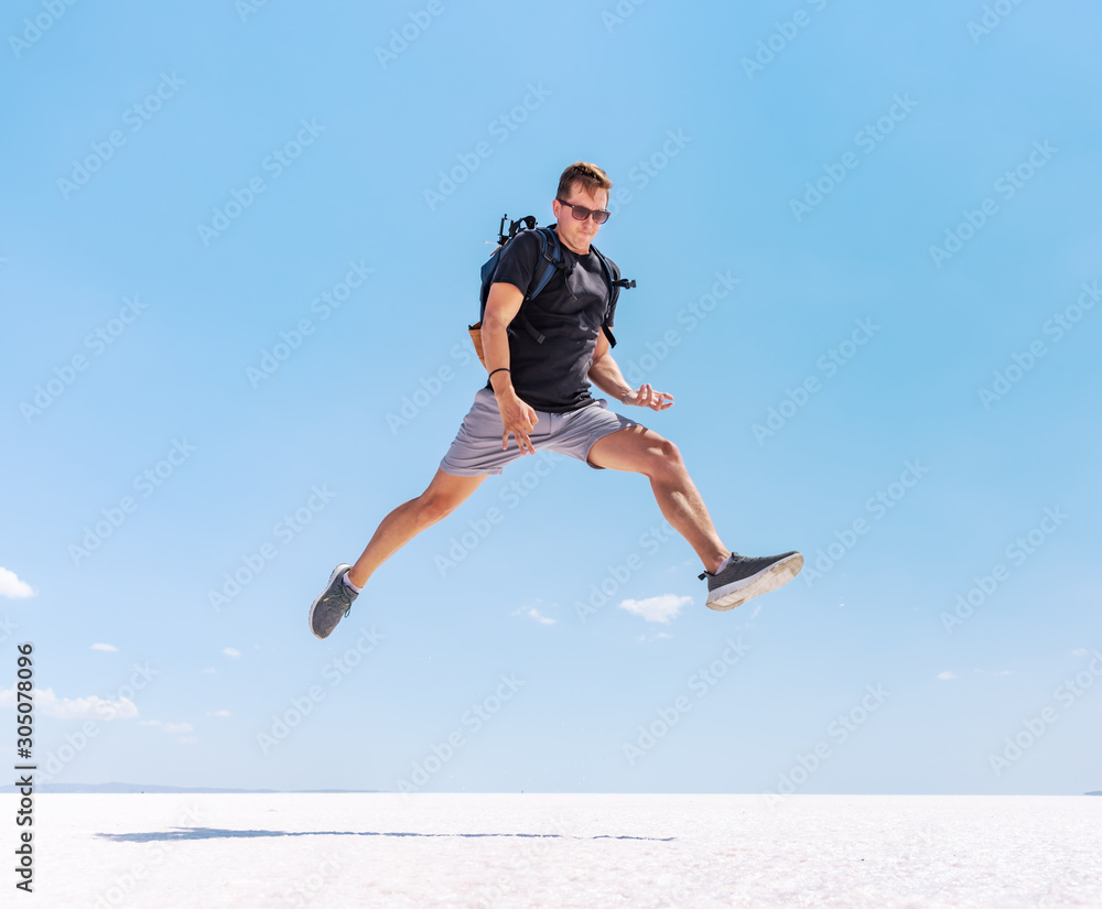 Traveling man jumping like a rock star at Tuz salt lake, Turkey. Rock and roll style concept. Traveling man jumping like a rock star at Tuz salt lake, Turkey. Rock and roll style concept.