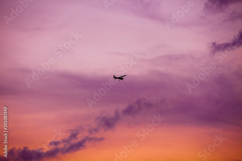 airplane flying at sunset