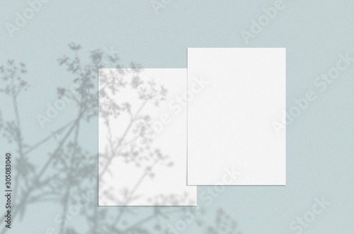 Blank white vertical paper sheet 5x7 inches with shadow overlay. Modern and stylish greeting card or wedding invitation mock up.