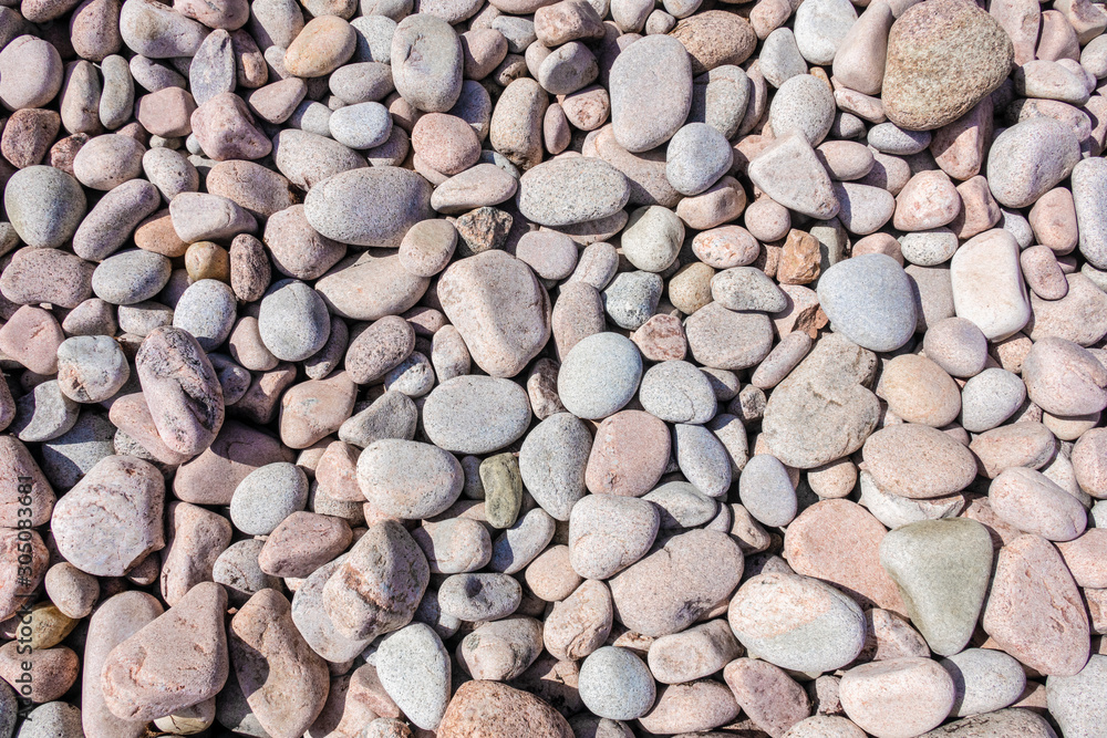 Pebbles on the beach in various colours and random sizes Pebbles on the beach in various colours and random sizes