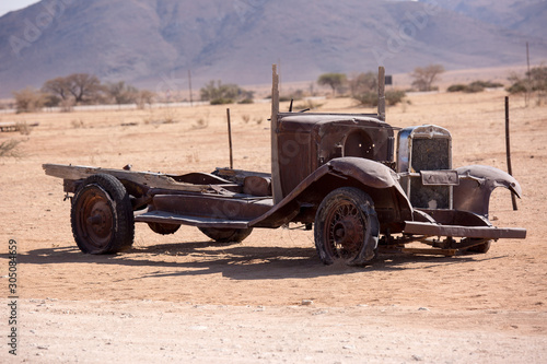 Abandoned old rusty wrecked historic car near a service station at Solitaire in Namibia desert ear the Namib-Naukluft National Park.