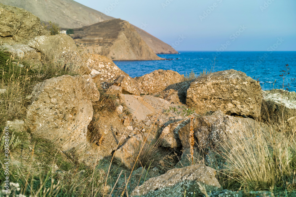 Cape Black sea in the village of Ordzhonikidze in the Crimea, in the summer with a textured sky with clouds. And hilly terrain, landscape