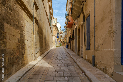 Shady medieval street in Birgu  Malta  near famous Inquisitor s palace. Authentic Maltese urban scene.