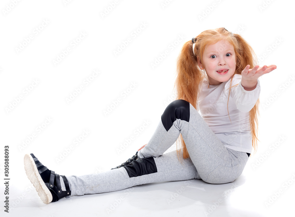 Fototapeta premium Red haired girl sitting on a white background and asking pulls his hand