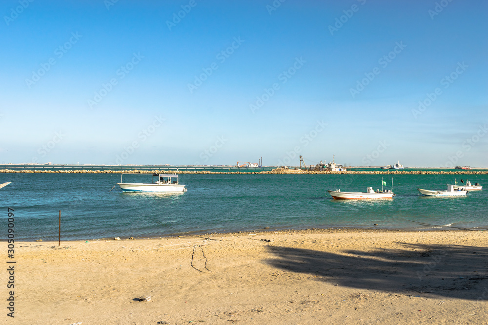 many modern speed boats floating on the sea water in a bright and beautiful day with blue sky in the background