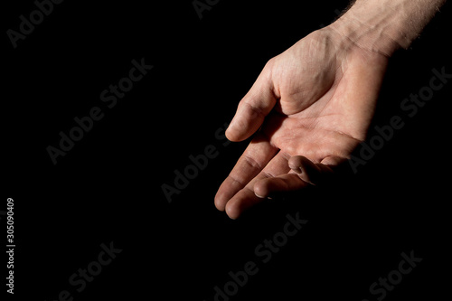 Men's palm in full dark under studio lighting, or "Helping Hand"