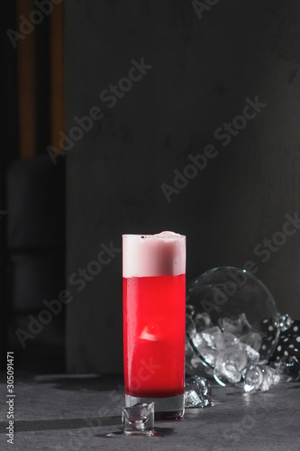 Red cocktail in glass. black background with copy space