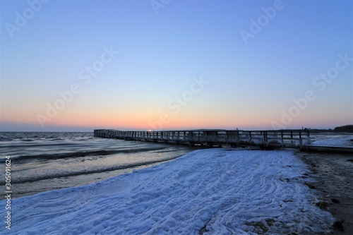 frozen seabridge with beautiful shore line in winter
