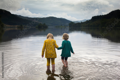 Two small children playing in a Scottish loch