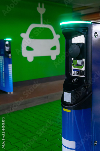 Symbol sign of electric cars charging station. Plug-in charger or socket for PHEV cars or vehicles. Concept of green electricity, clean environment, emission reduction.