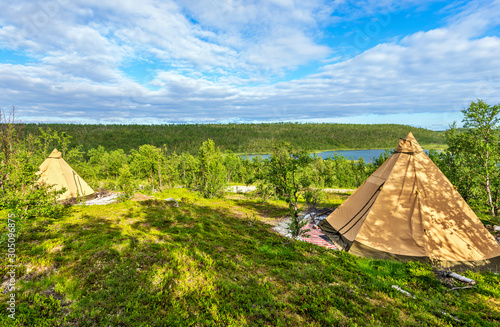 Sami style lavvo-like tents in the tundra of  Kautokeino region in Norwegian finnmark. Dalloluoppal lake is at background.
