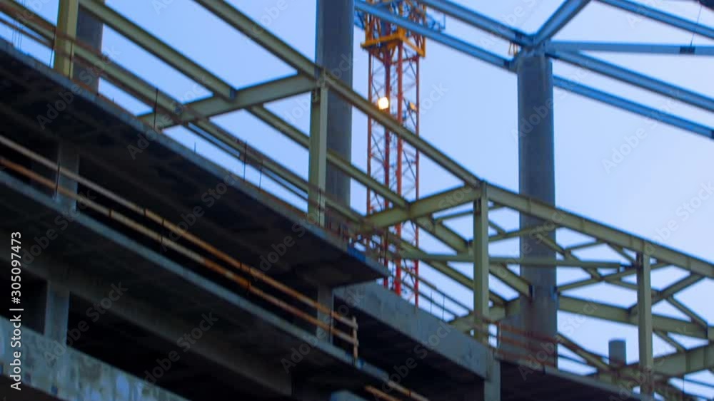 High-altitude crane, metal girders and concrete walls - this is the construction of a new stadium High-altitude crane, metal girders and concrete walls - this is the construction of a new stadium
