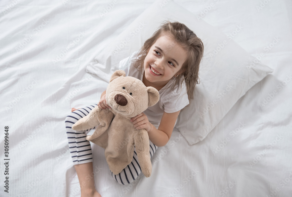 Cute little girl in bed with soft toy. Cute little girl in bed with soft toy.