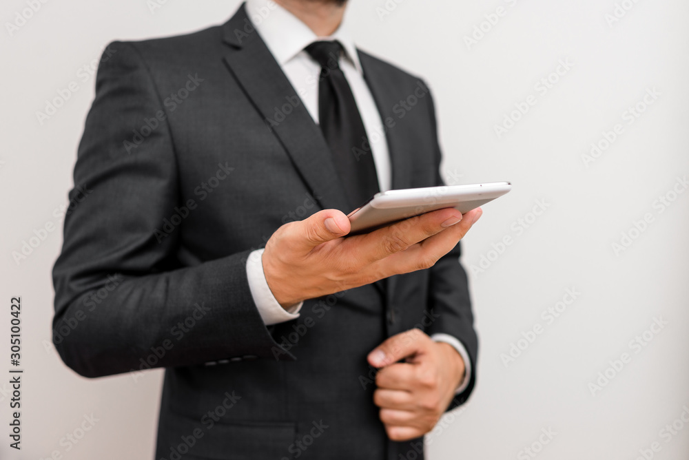 Male human wear formal work suit hold smart hi tech smartphone use one hand Male human wear formal work suit hold smart hi tech smartphone use one hand