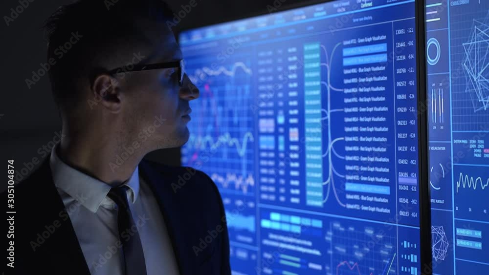 The businessman working with monitors in a lab
