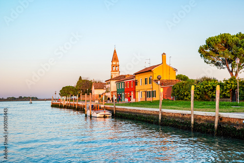 Colorful houses at sunset on the small island Mazzorbo in the northern Venetian Lagoon photo