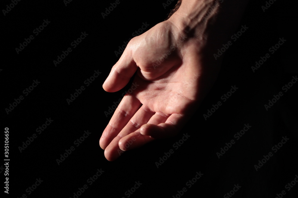 Men's palm in full dark under studio lighting, or Men's palm in full dark under studio lighting, or